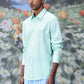 Stylera model wearing mint green button down malmal regular fit formal shirt with long sleeves