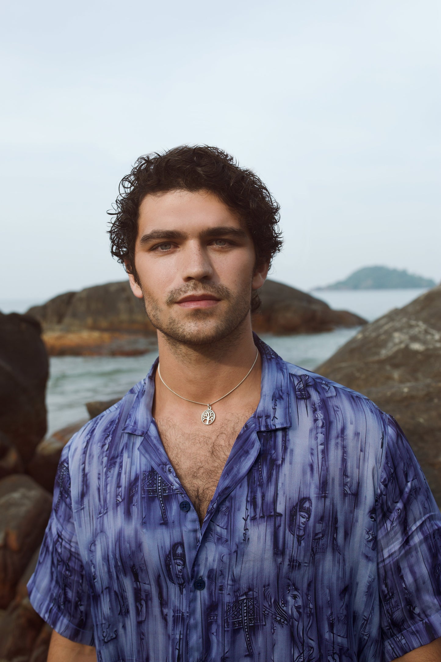 Men's abstract blue oversize shirt by Stylera modeled by a man outdoors