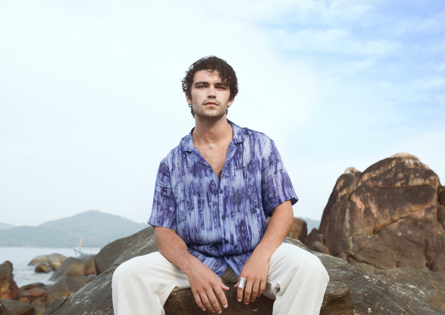 Men's abstract blue oversize shirt styled with light-colored pants for casual outings