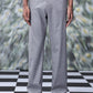 Grey men's business casual trousers by Stylera worn with black shoes on checkered floor