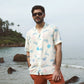 Men's cream oversize shirt with playful animal prints, perfect for beach outings