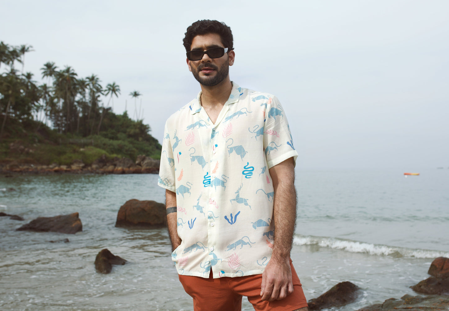 Men's cream oversize shirt with playful animal prints, perfect for beach outings