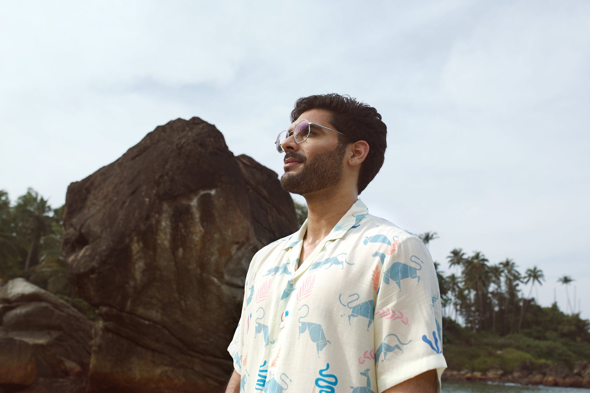Men's cream oversize shirt by Stylera with playful animal prints, perfect for casual beach outings