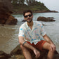 Men's cream oversize shirt with playful dinosaur prints, perfect for beach outings and casual wear