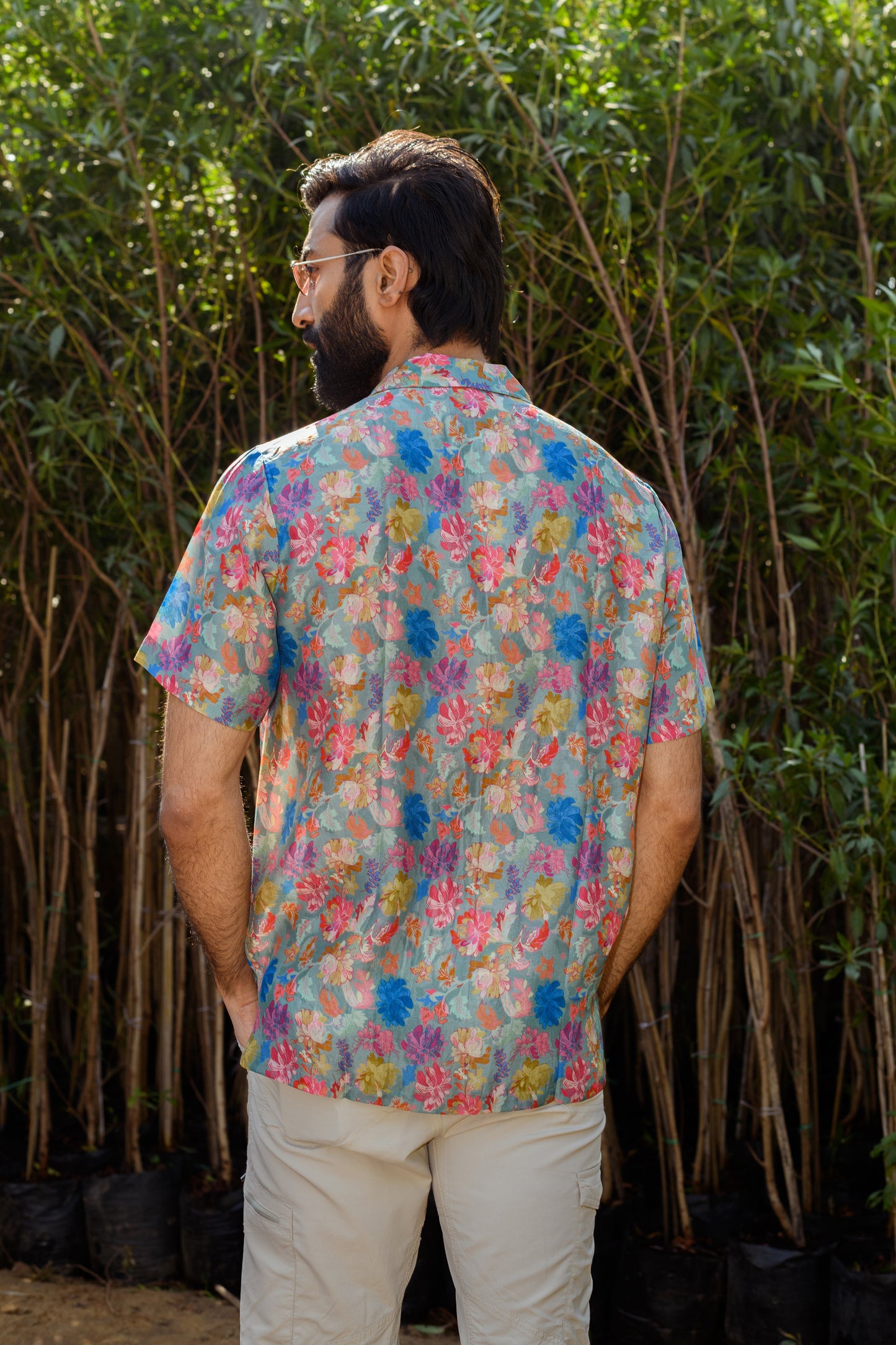 Back view of a men's floral Hawaiian shirt by Stylera, featuring vibrant floral patterns.