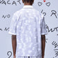 Back view of mens ikkat print polo by Stylera in white with subtle patterns
