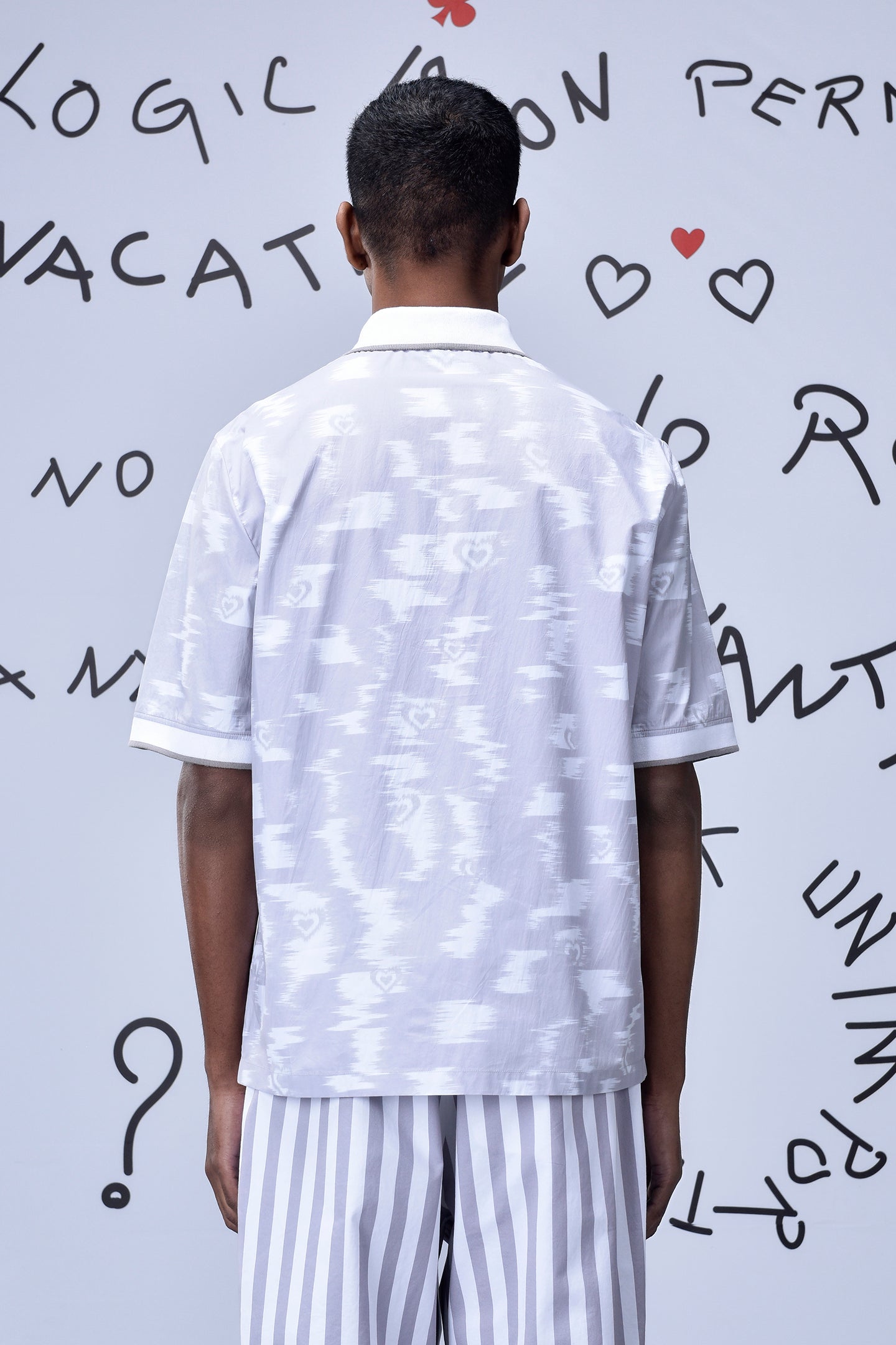 Back view of mens ikkat print polo by Stylera in white with subtle patterns