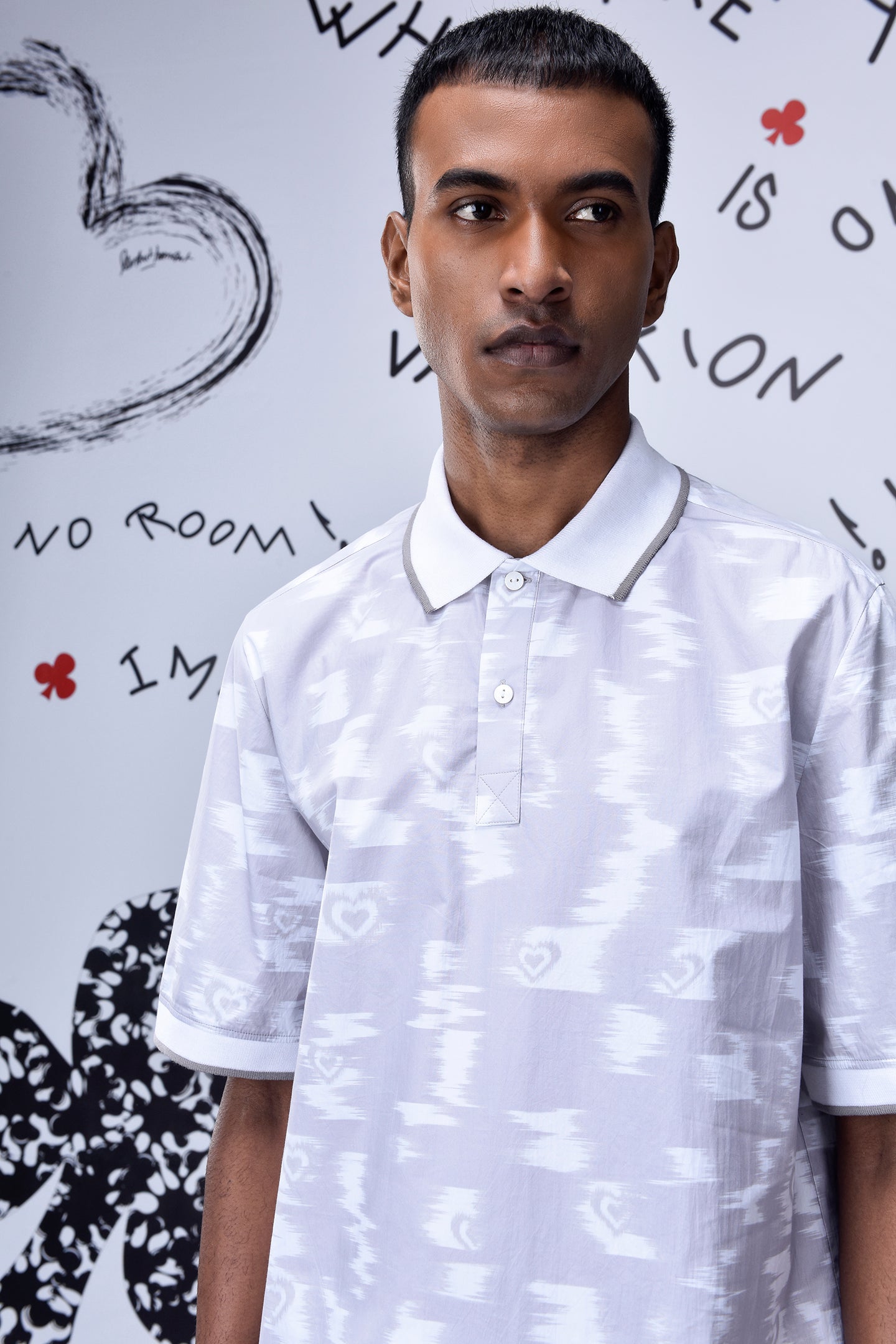 Mens ikkat print polo T-shirt by Stylera in white with subtle heart patterns
