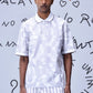 Men wearing Stylera mens ikkat print polo in white with subtle geometric patterns