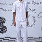 Men wearing Stylera mens ikkat print polo in light color with striped pants