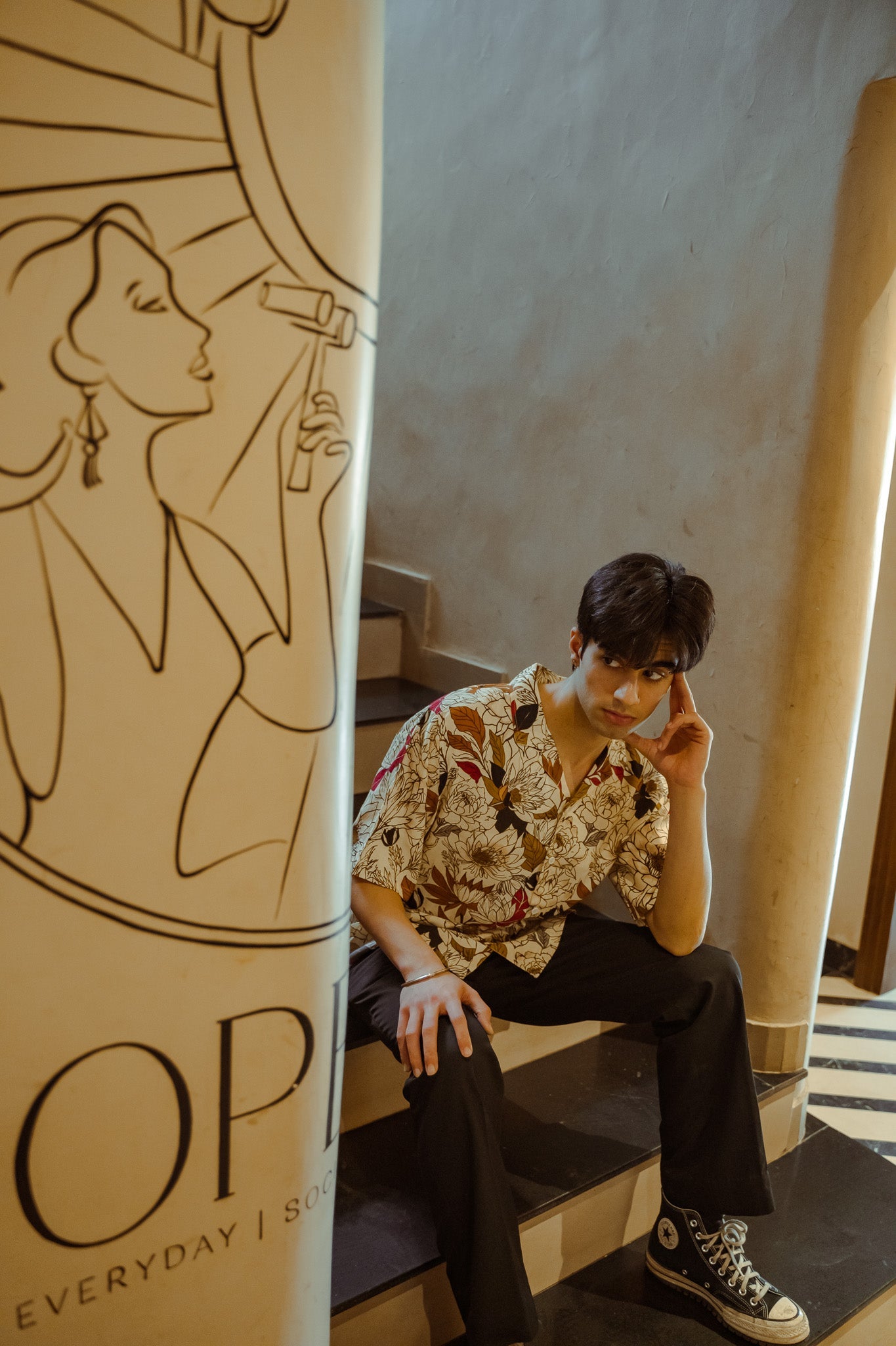 Men's oversized floral shirt by Stylera, styled with casual black pants