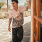 Stylera model wearing men's printed casual button up shirt with scenic vintage print short sleeves and sunglasses