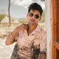 Model wearing Stylera men's printed casual button up shirt in pink with scenic print short sleeve resort style