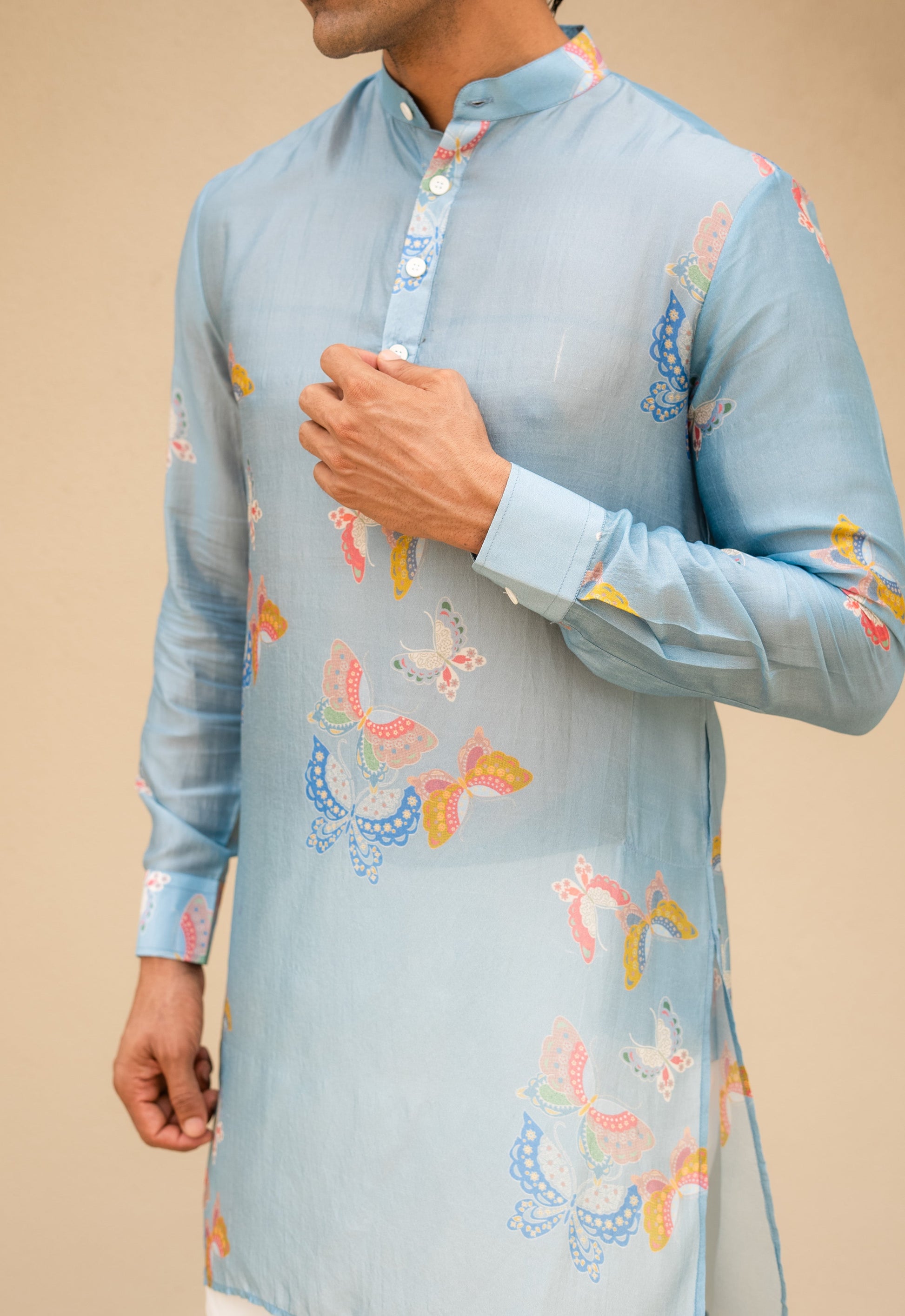Men's printed kurta with butterfly design in light blue fabric, featuring colorful butterfly patterns