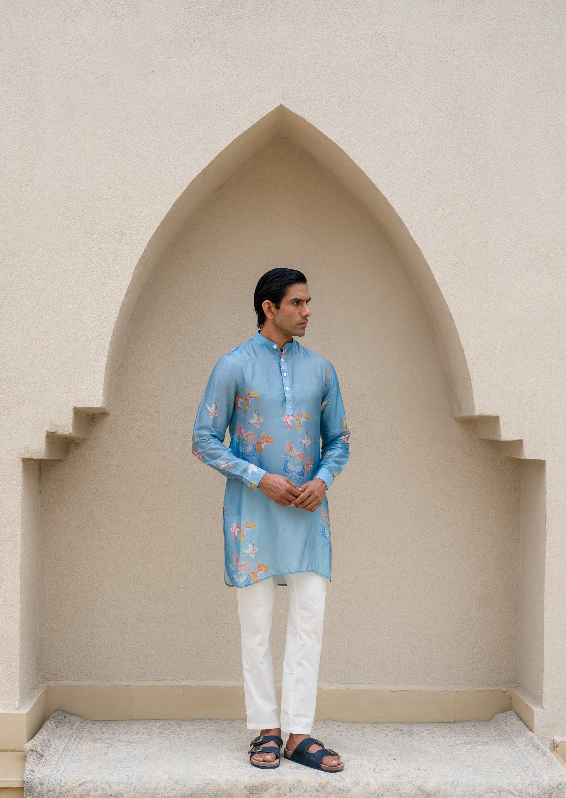 Men's printed kurta with butterfly design in blue, featuring traditional styling and elegant details