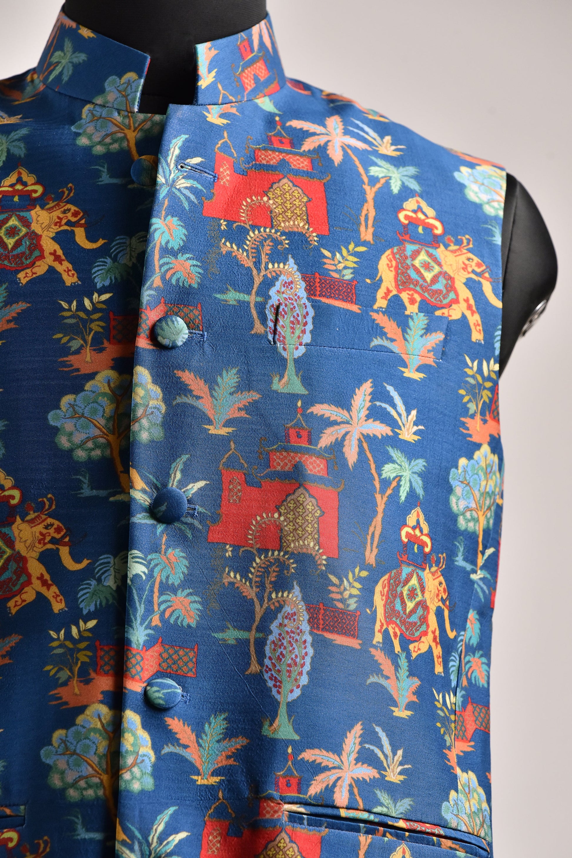 Men's printed silk Nehru jacket in vibrant blue with intricate patterns and detailed designs
