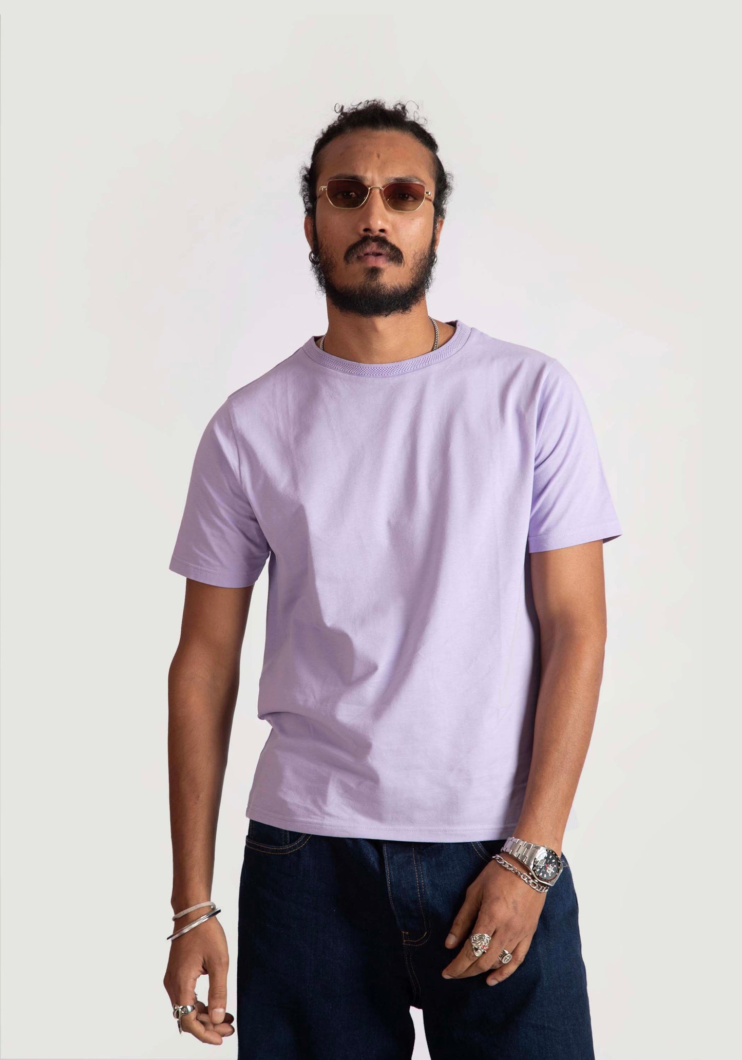 Man wearing Stylera men's regular fit lavender tee paired with dark jeans and sunglasses
