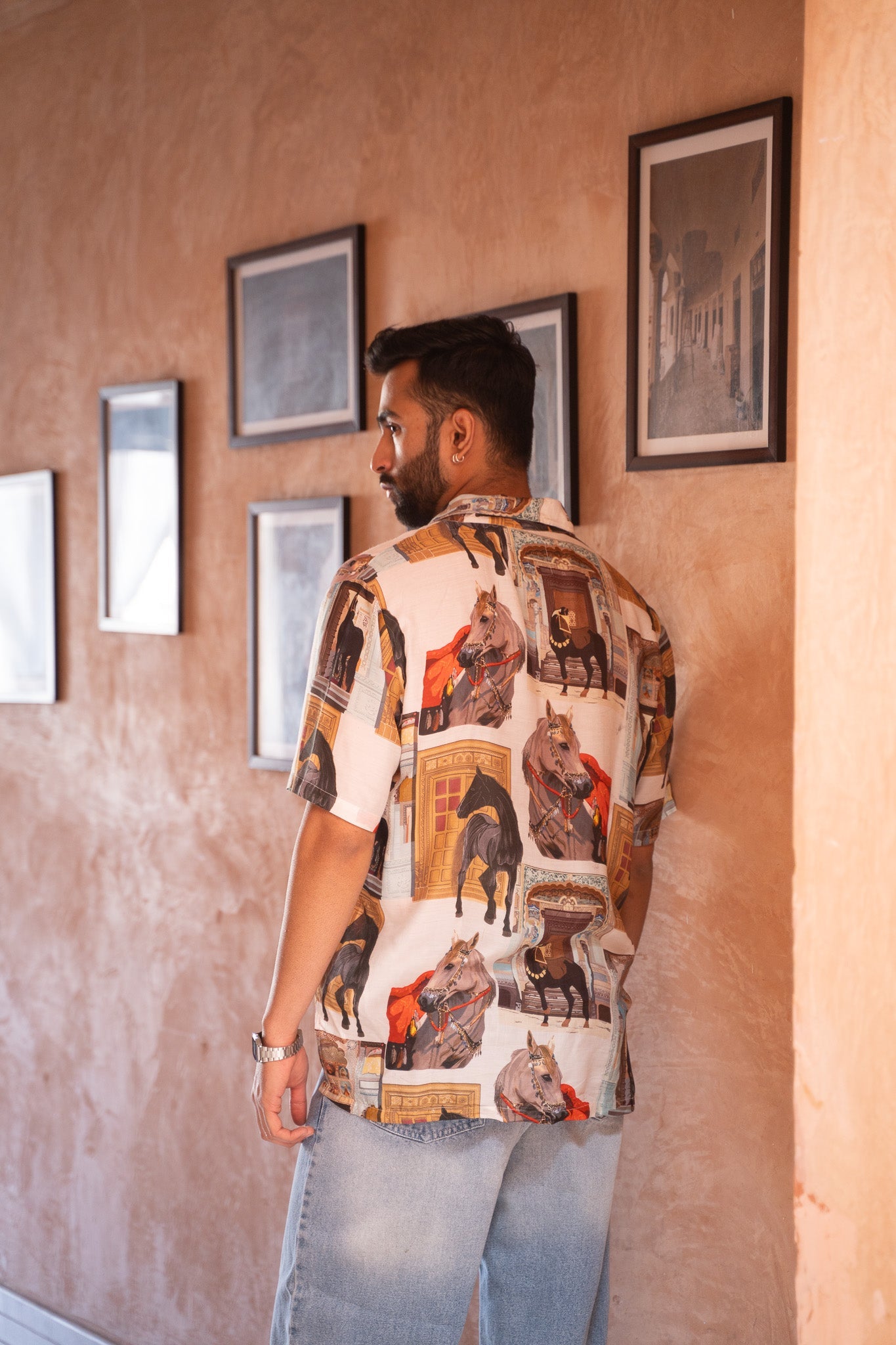 Men's statement oversized shirt with artistic prints displayed in a stylish setting