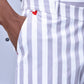 Close-up of men's striped lounge pants by Stylera featuring white and gray vertical stripes and a small red heart detail
