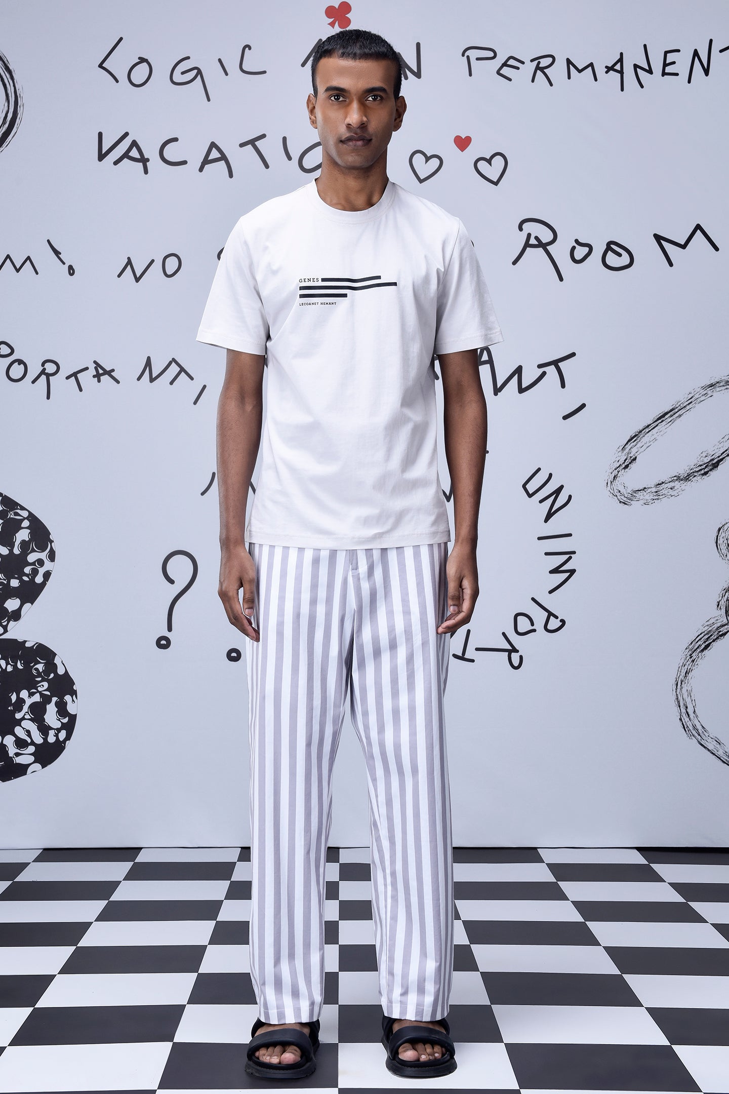 Men wearing Stylera men's striped lounge pants in white and gray with a white t-shirt