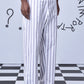 Stylera men's striped lounge pants in white and gray vertical stripes styled with black sandals