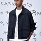 Male model wearing Stylera black casual jacket men's boxy cropped silhouette over graphic tee