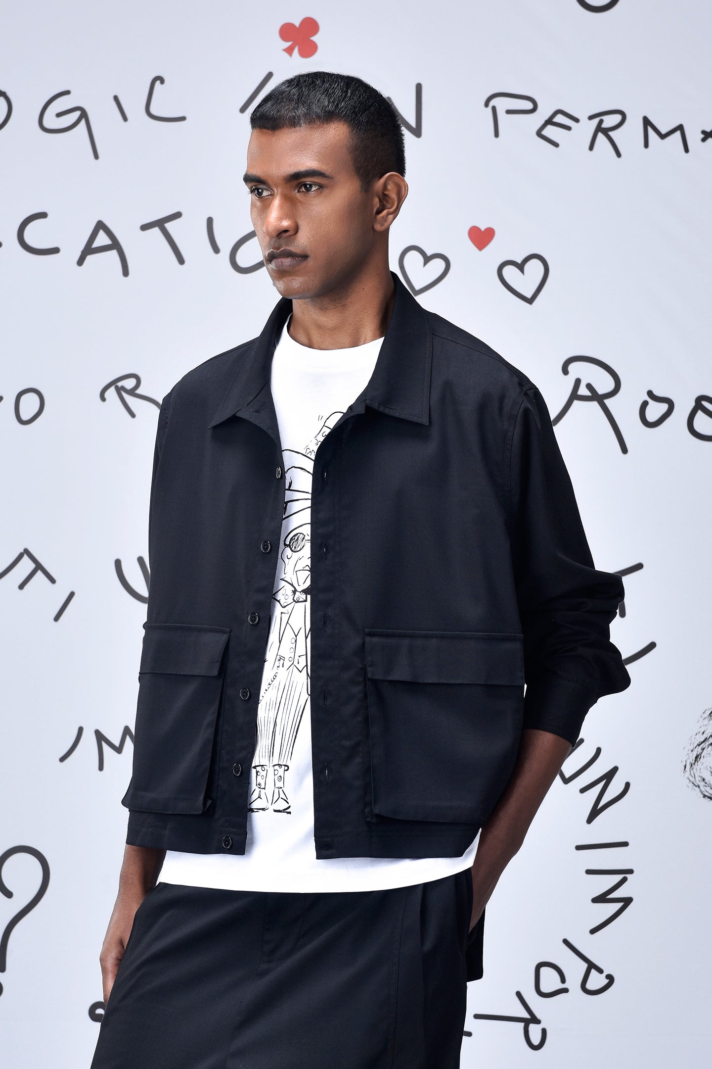 Male model wearing Stylera black casual jacket men's boxy cropped silhouette over graphic tee