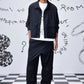 Stylera model wearing black casual jacket men's with white graphic tee black cargo pants and sneakers