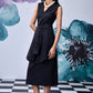 Model in Stylera midi black dress with belt V neck sleeveless styling pearl necklace and sandals