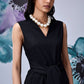 Stylera midi black dress with belt sleeveless V neck model wearing pearl necklace