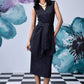 Stylera model wearing midi black dress with belt sleeveless V neck sheath and side tie