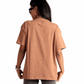 Back view of a woman wearing a Mocha Brown oversized t-shirt by Stylera paired with gray jeans