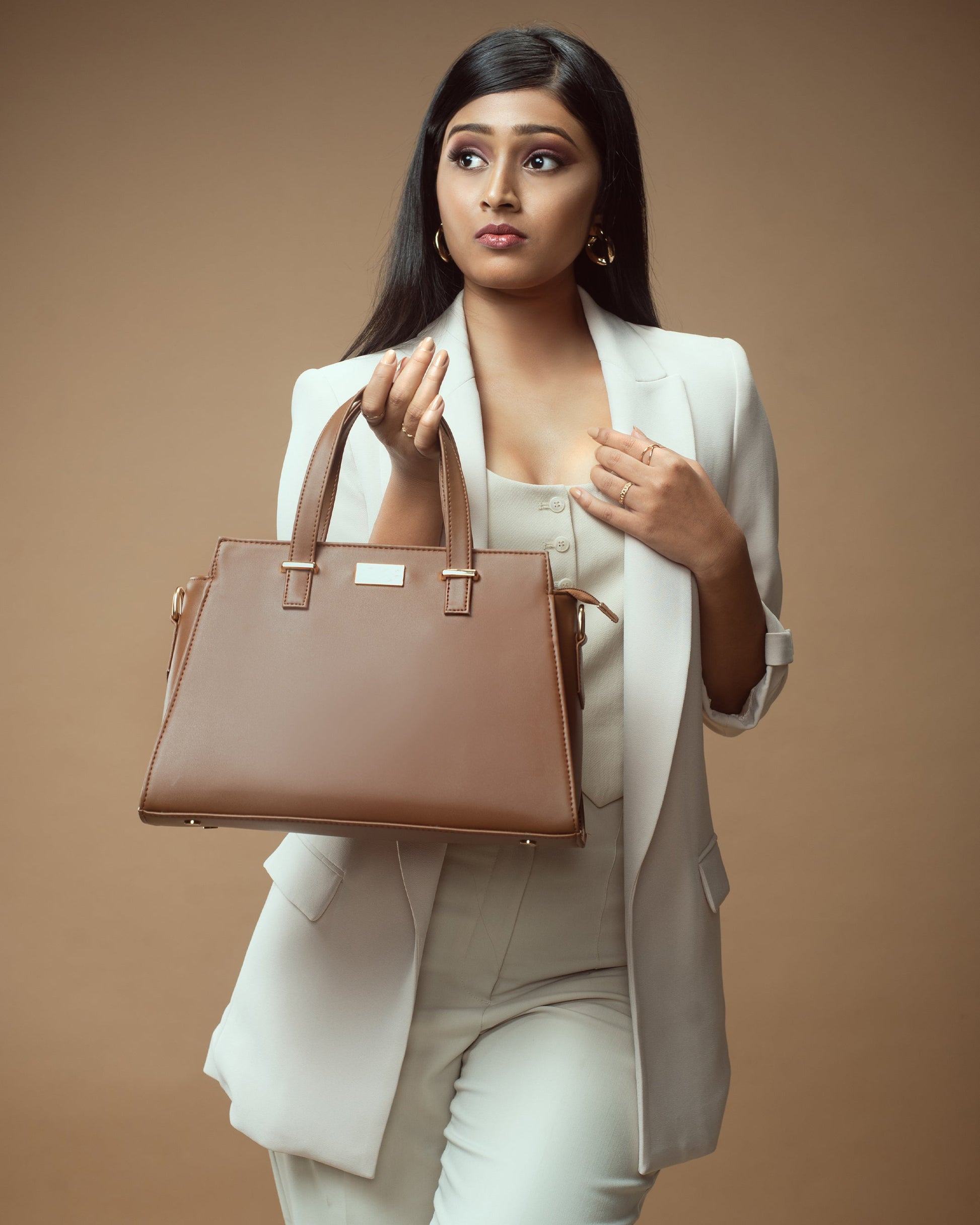 Mocha elegance handbag showcased by a model in a chic outfit, perfect for stylish outings