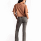 Stylera mocha oversized crop top worn by woman paired with gray jeans and black shoes