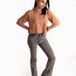 Woman wearing mocha oversized crop top from Stylera paired with gray jeans and black shoes