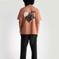 Back view of model wearing Stylera mocha oversized t-shirt with graphic design and black pants