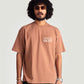 Stylera mocha oversized t-shirt worn by a man with curly hair and sunglasses