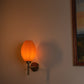 Sozori modern decorative wall lighting with a textured orange glass shade on a wall