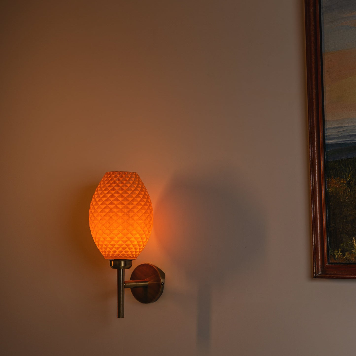 Sozori modern decorative wall lighting with a textured orange glass shade on a wall