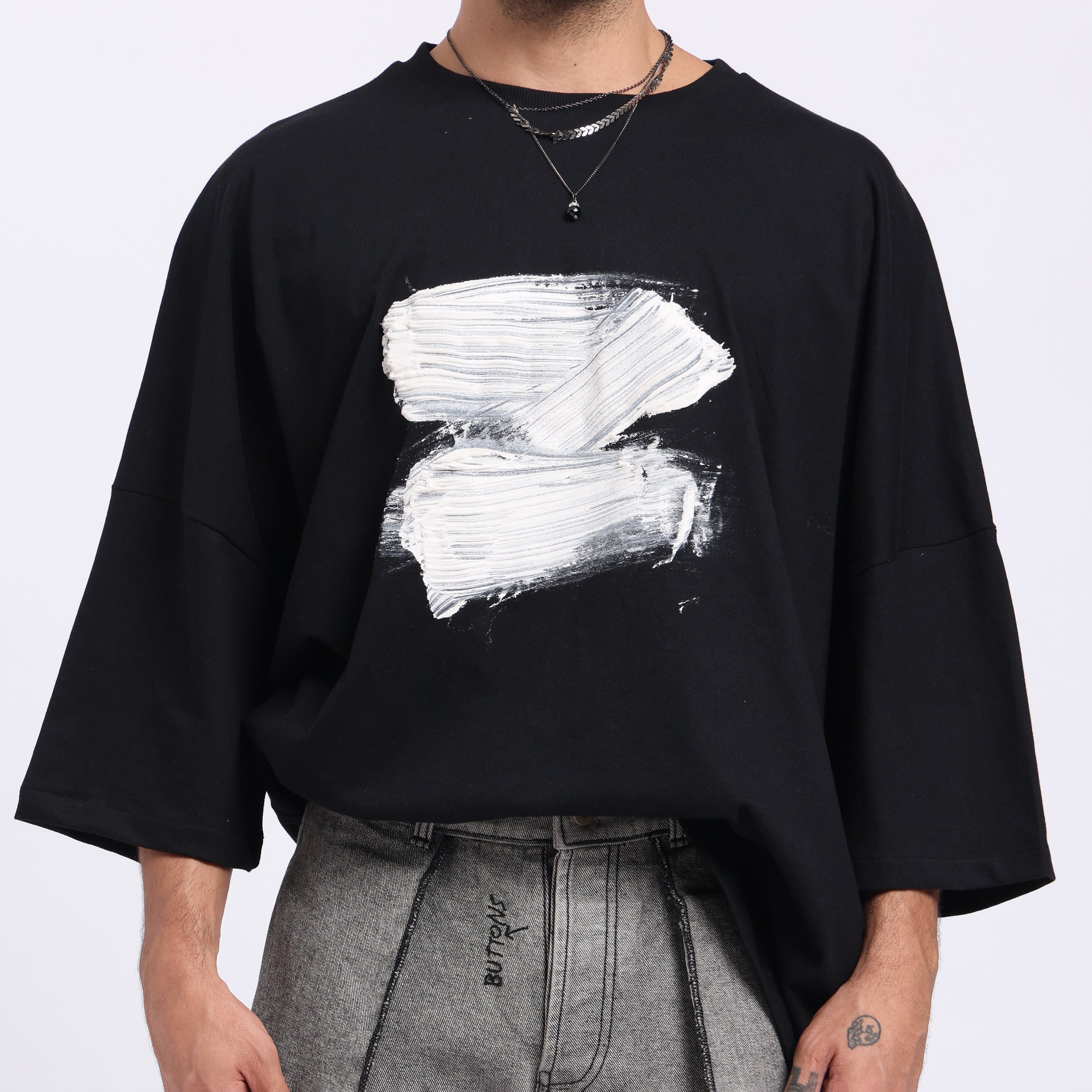 Stylera modern streetwear black t-shirt featuring a bold white abstract design on the front