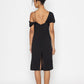 Back view of Stylera moonlit tide cocktail dress in black with off-shoulder and slit detail