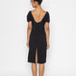 Back view of woman wearing black moonlit tide cocktail dress by Stylera with low back and slit