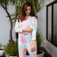 Model wearing a stylish multicolor neon jacket and joggers set, perfect for casual outings