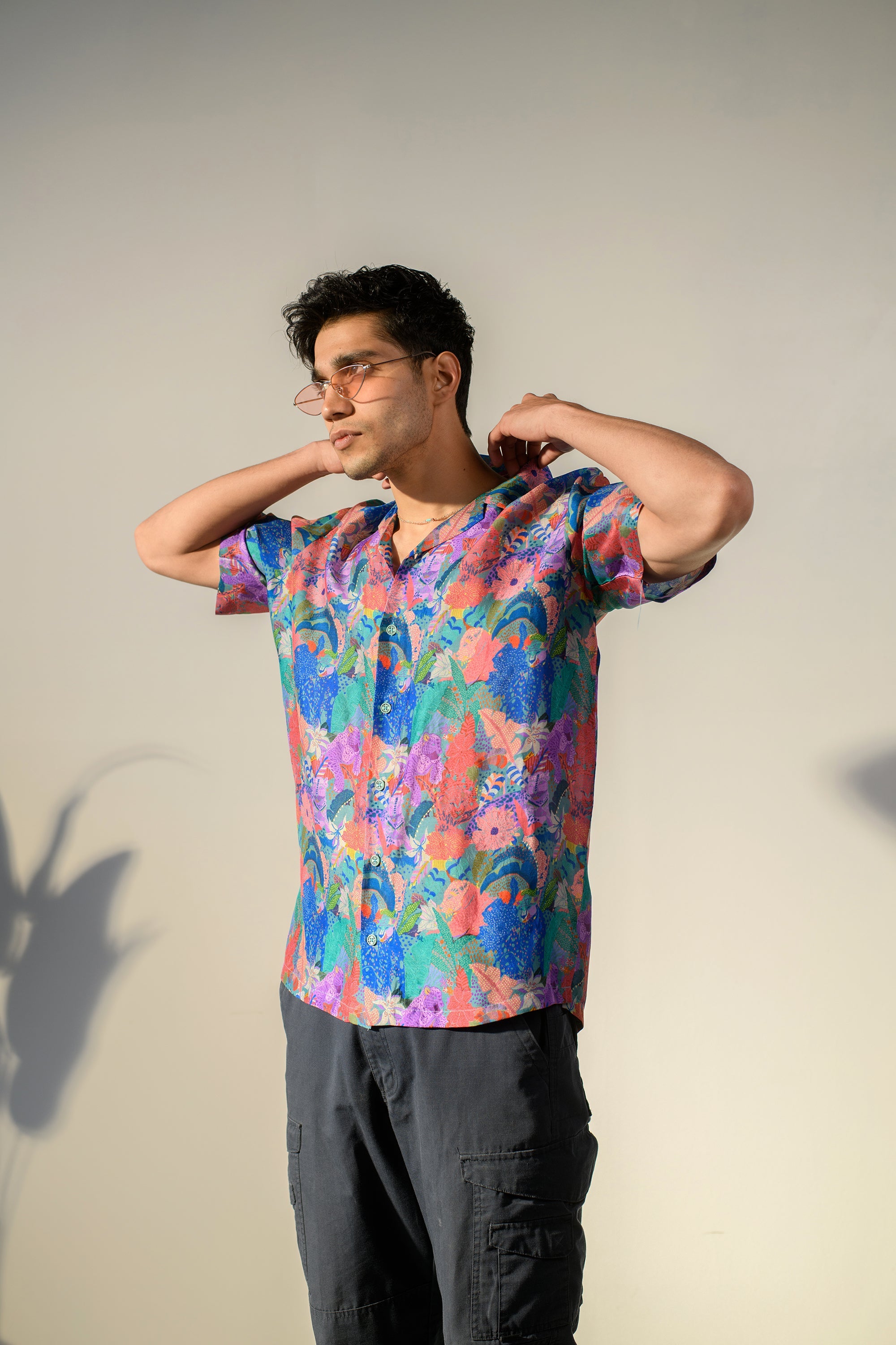 Stylish man wearing a multicolor oversized russian silk shirt in a vibrant floral pattern