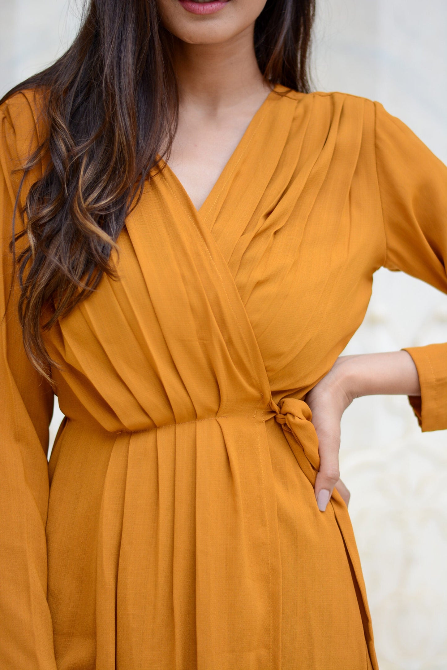 Elegant mustard wrap dress with pleats and a flattering tie waist detail