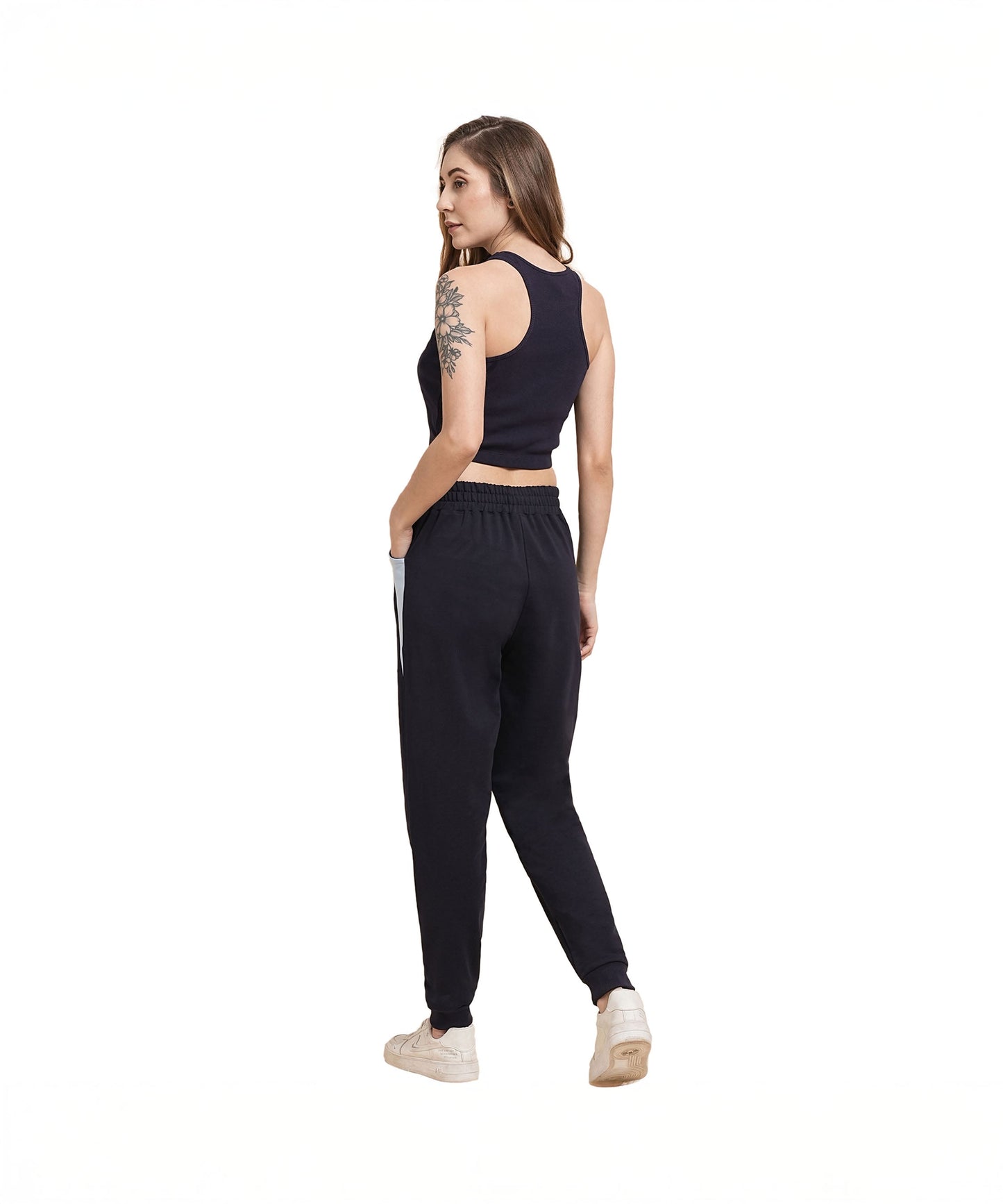 Back view of a woman wearing navy blue joggers for women paired with a sporty top