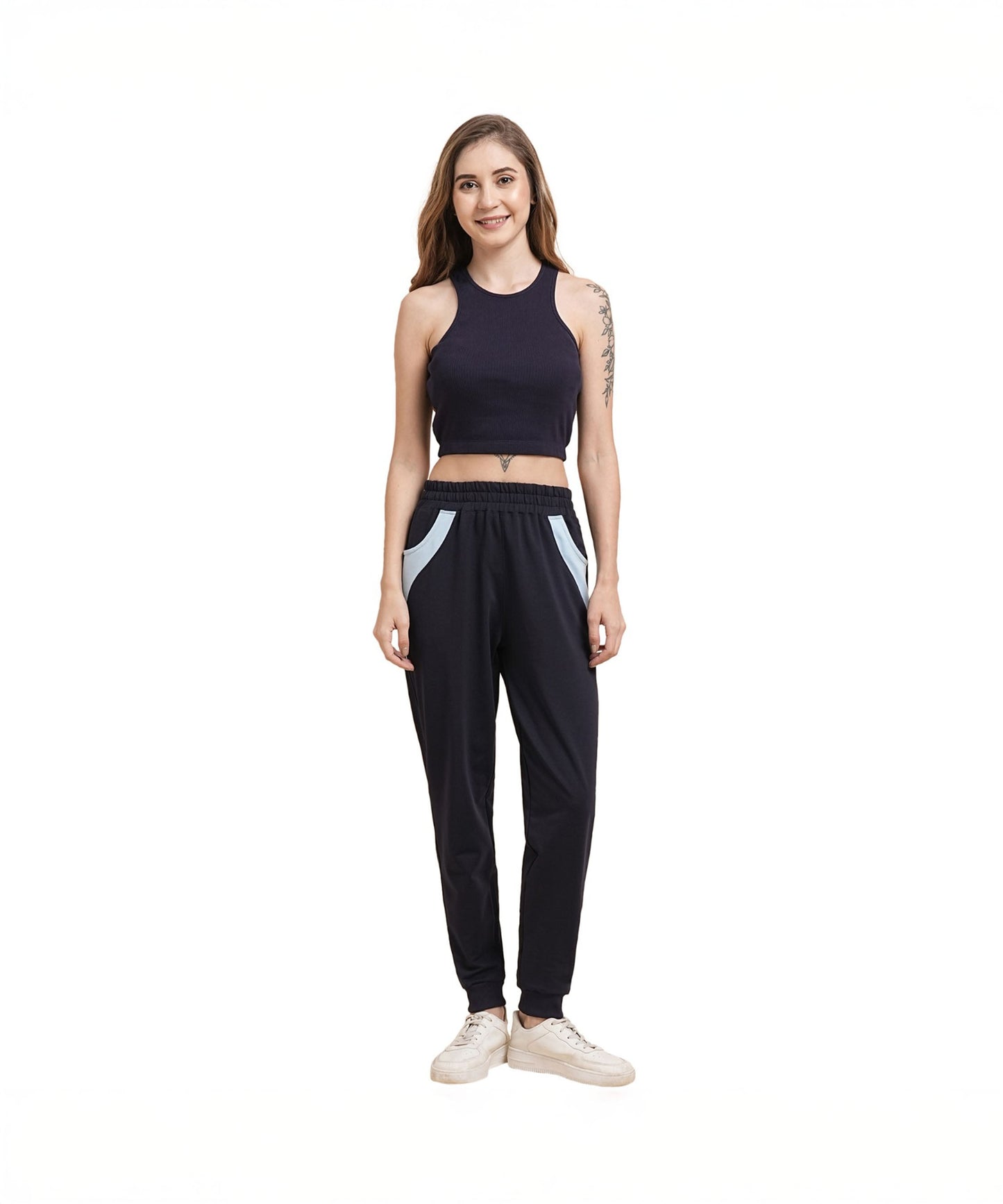 Model wearing navy blue joggers for women with side pockets and a fitted crop top