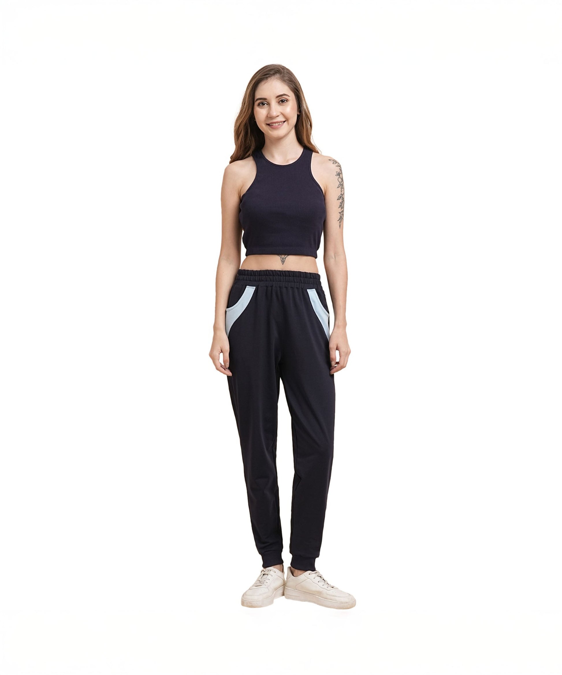 Model wearing navy blue joggers for women with side pockets and a fitted crop top