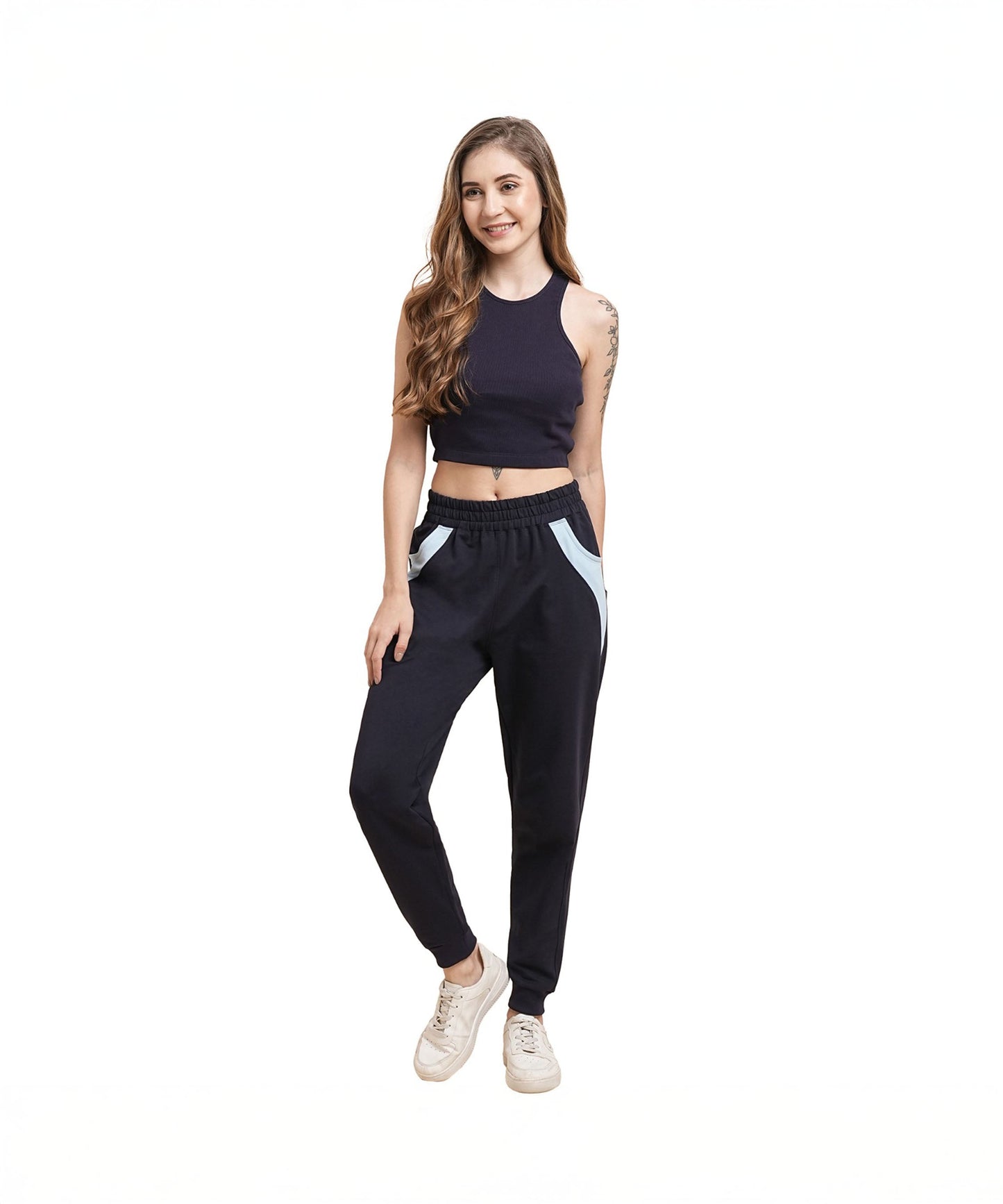 Stylish woman wearing navy blue joggers for women with a trendy cropped top and sneakers