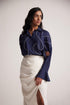 Woman wearing a navy blue oversized cotton shirt with white embroidery from Stylera